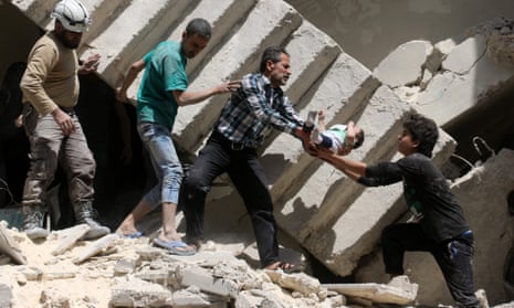 Volunteers and rescuers rescue a baby from the rubble of a destroyed building after a reported airstrike on the rebel-held neighbourhood of al-Kalasa in Aleppo