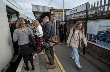 People get on and off a train at Hitchin station