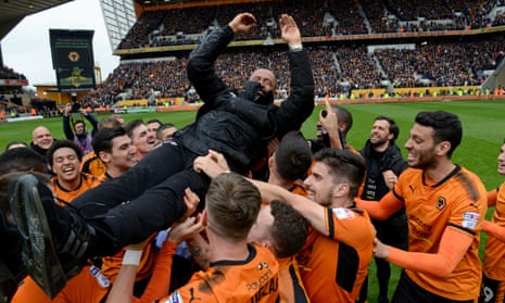 The Wolves players celebrate promotion to the Premiership by launching Nuno Espírito Santo into the air. 