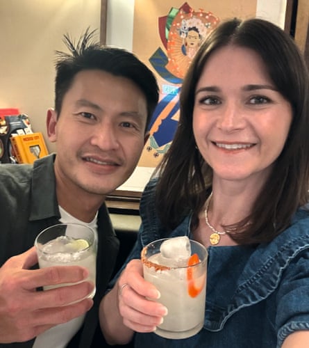 Nelson and Louise smile, each holding a cocktail