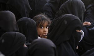 Yemeni women wait to receive food supplies