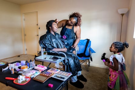 Denae Bettis, 23, center, applies makeup to Netanya Wilson, 26, as her daughter, Lei’lani Wilson Hart, 4, watches, at their home in Glen Burnie, Maryland