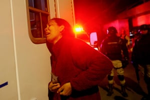 Viangly, a Venezuelan migrant, reacts outside an ambulance carrying her injured husband Eduard Caraballo after a fire at the National Migration Institute building in Ciudad Juarez, Mexico