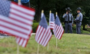 Virginia State Troopers stand near a memorial at the Virginia Beach Municipal Center.