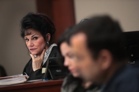 Judge Rosemarie Aquilina rests her chin on her hand, looking sternly towards Larry Nassar