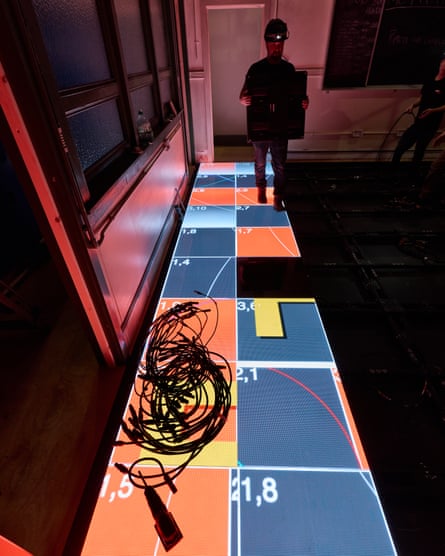 Laying digital LED panels that make up the set floor.