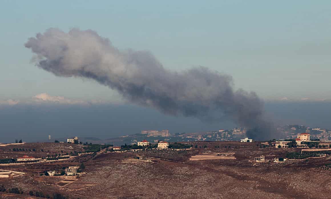 Smoke rising from settlement in the distance