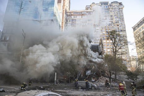 First responders attend the site of a drone attack in Kyiv earlier this morning.