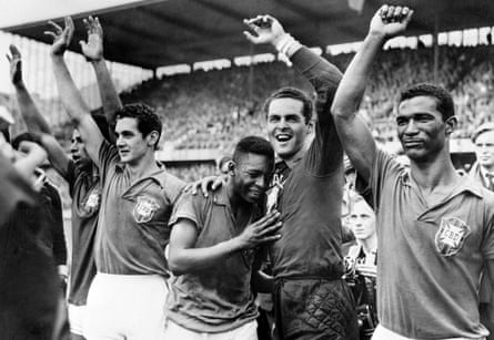 A 17-year-old star Pelé weeps on the shoulder of the goalkeeper Gilmar after Brazil win the 1958 World Cup.