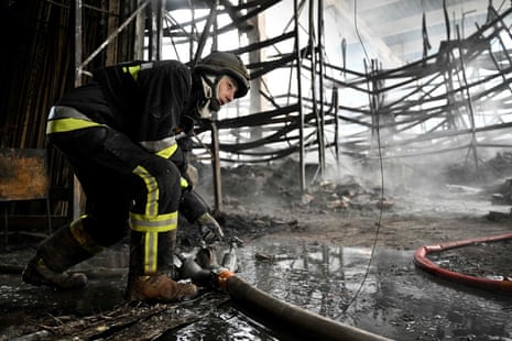 A Ukrainian firefighter works to put out a fire in a shopping mall after Russian shelling in Kherson on 3 February.