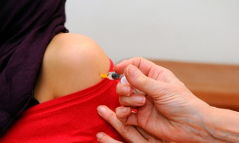 A woman receives a meningitis C vaccination.