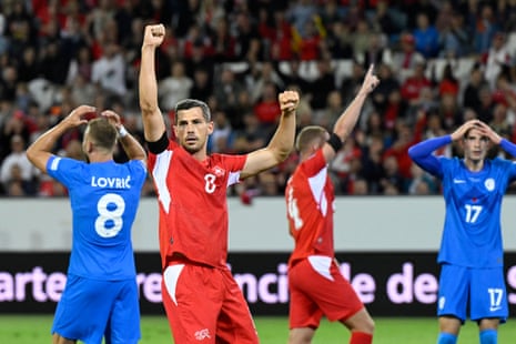 Switzerland's Remo Freuler and teammates celebrates their first goal, an own goal scored by Slovenia's Erik Janza.
