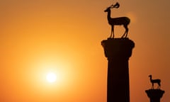 The deer statues at the entrance to Rhodes harbor at sunrise<br>Sunrise. Deer Rhodes Greece City of Rhodes Greece, Statues of fallow deer at the entrance to Mandraki