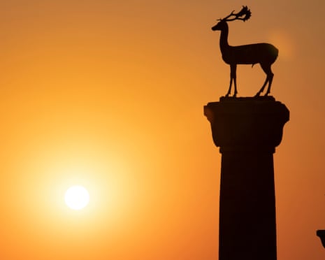 The deer statues at the entrance to Rhodes harbor at sunrise<br>Sunrise. Deer Rhodes Greece City of Rhodes Greece, Statues of fallow deer at the entrance to Mandraki