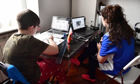Two students doing schoolwork at home in Genova, Italy in March.