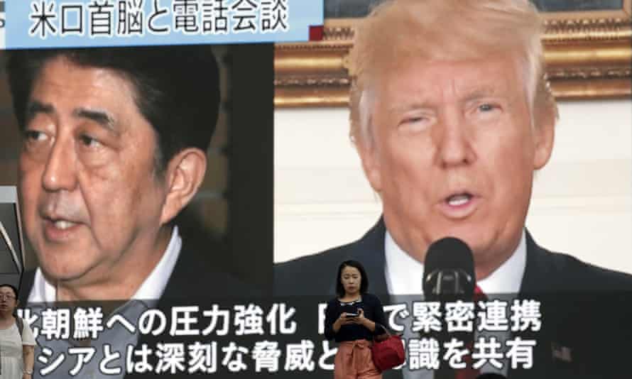 In Tokyo, people walk past a news broadcast showing Japanese prime minister Shinzo Abe and US president Donald Trump following North Korea’s nuclear test.