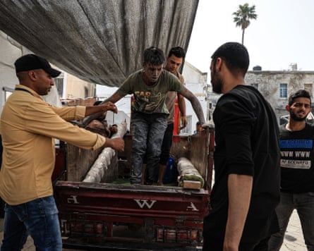 Injured people are helped off a cart