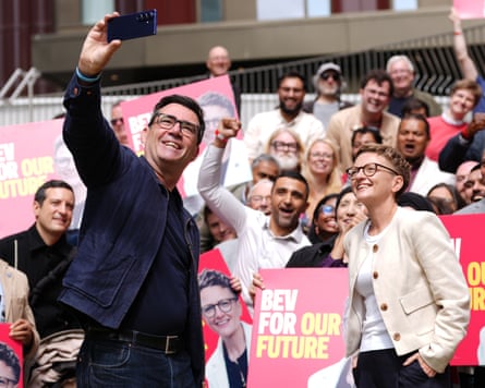 Andy Burnham taking a selfie alongside Bev Craig at a campaign rally during the July 2026 Greater Manchester mayoral by-election.