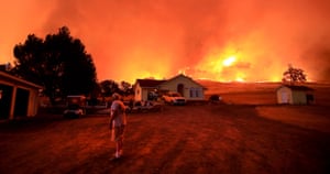 A resident of Morgan Valley Road, near Lower Lake in California, prepares to evacuate as wildfires approach