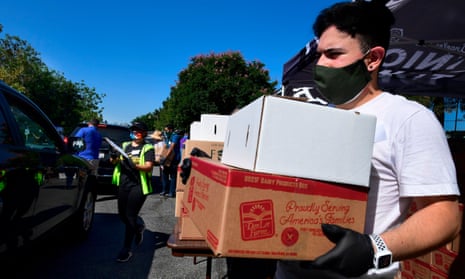 Volunteers help load a vehicle with boxes of food at a food bank in the Los Angeles County city of Duarte, California on 8 July 2020 as the record for most coronavirus cases in a single day is set in California.