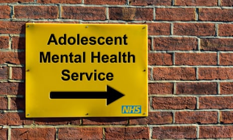 Yellow NHS sign pointing to Adolescent Mental Health Service department