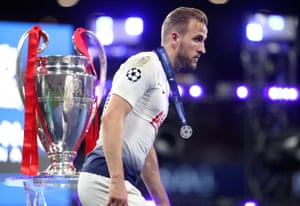 Tottenhamâs Harry Kane walks past the trophy after collecting his loserâs medal.