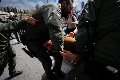 Police scuffle with a protester in Jerusalem.