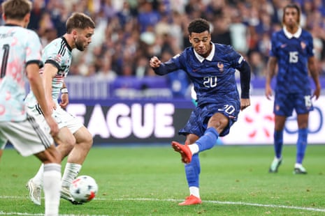 France's forward Desire Doue shoots and scores his team's first goal.