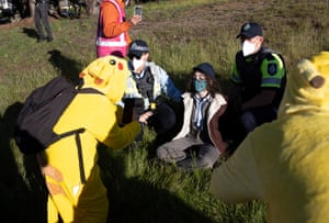 An Extinction Rebellion protestor dressed as Pikachu is detained after rushing the prime minister’s car as he drove into Parliament House in Canberra on Monday.