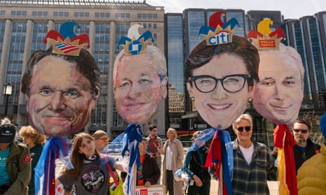 Activists hold likenesses of bank CEOs during a protest in Washington DC on 21 March. 