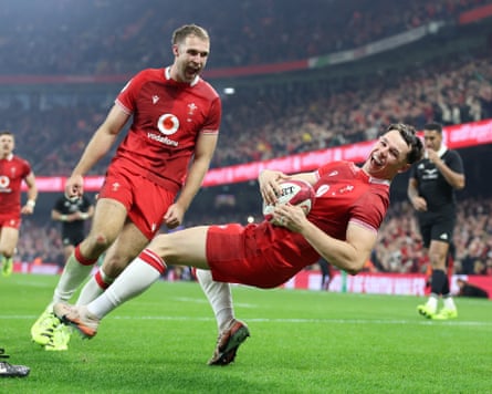 Wales’s Tom Rogers spins home for his historic third try.