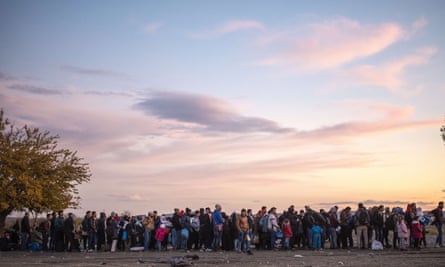 People queue at a registration centre after crossing the border between Greece and Macedonia.