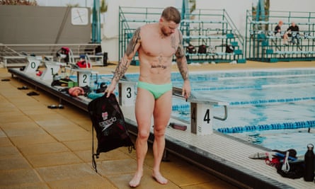 Adam Peaty out of the pool with a tattoo on his stomach reading: ‘Into the light’