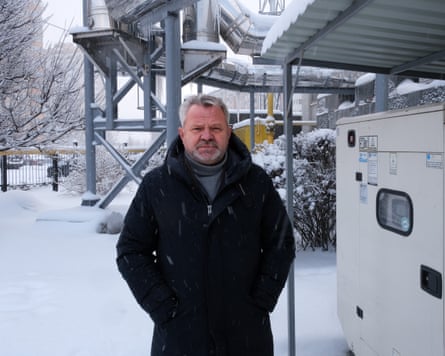 Anatolli Fedoruk in the snow stands in front of an emergency generator