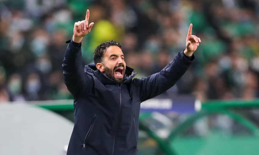 The Sporting head coach, Rúben Amorim, raised both his arms while stood on he touchline during a game
