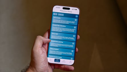 A person holding a phone displaying the Soaak app