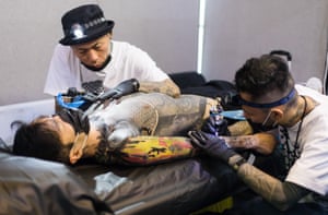 Tattoo artists at work