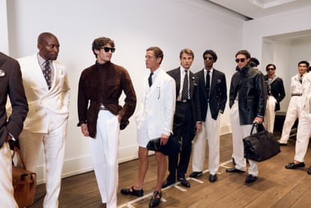 Models in white, cream, brown and black clothes backstage at the Ralph Lauren show