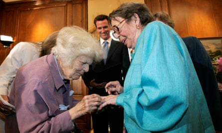 Del Martin and Phyllis Lyon exchange rings during their wedding ceremony officiated by Gavin Newsom (center) at City Hall in San Francisco.