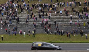 Spectators watch as the cortege on the M90 motorway makes its journey to Edinburgh from Balmoral