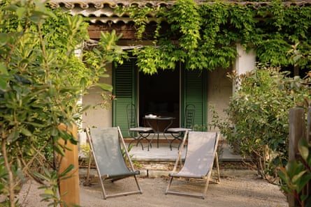 Deckchairs outside a leafy doorway in France