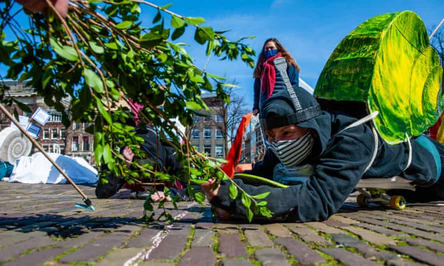 XR activists dressed as snails protest against the slow movement towards net-zero emissions in The Hague, Netherlands, on 3 April 2021.