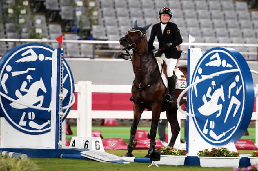 Annika Schleu of Germany on Saint Boy after hitting an obstacle; she left the arena in tears.