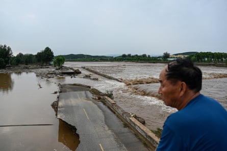 A damaged road at a flooded area in Miyun district.