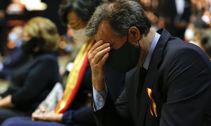A person reacts as people attend a tribute to the victims of the Covid-19 in the cathedral of Seville.