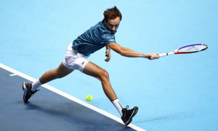 Daniil Medvedev stretches to play a backhand against Stefanos Tsitsipas.