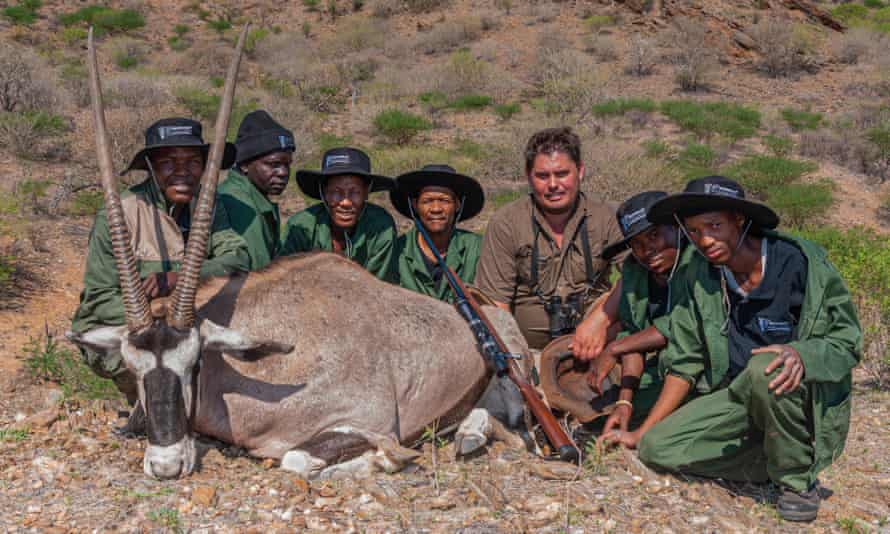 A hunter poses with local wildlife guides and a gemsbok that was shot during a hunt in Namibia.