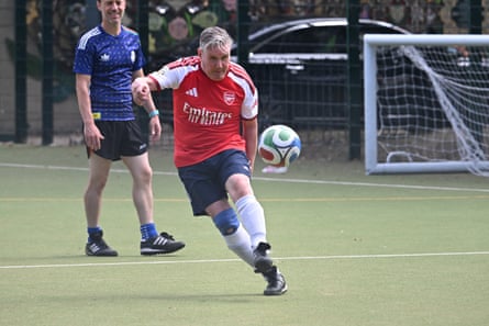 Keir Starmer in Arsenal top playing football on Astroturf