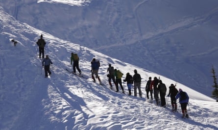 Students and instructors head up a hill on snowshoes during an avalanche awareness field trip for teenagers, at Mount Baker, Wash.