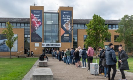 Students queue during moving-in day at the University of Surrey in Guildford